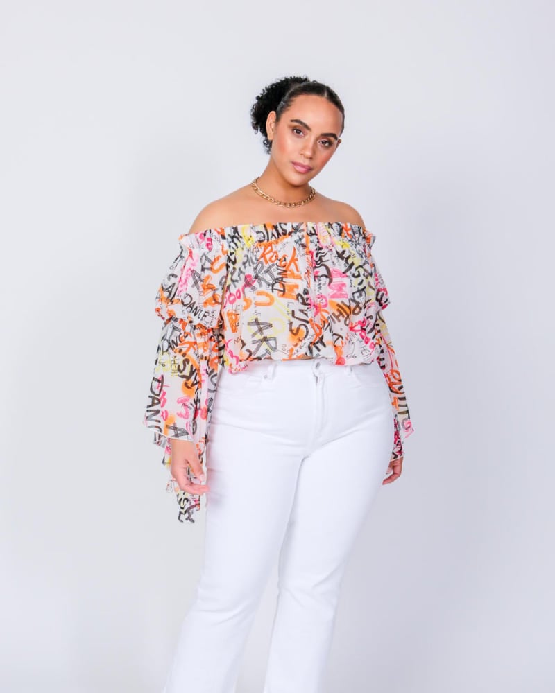 Front of a model wearing a size L Brittney Off The Shoulder Top in Graffiti Print by LuvMeMore. | dia_product_style_image_id:266548
